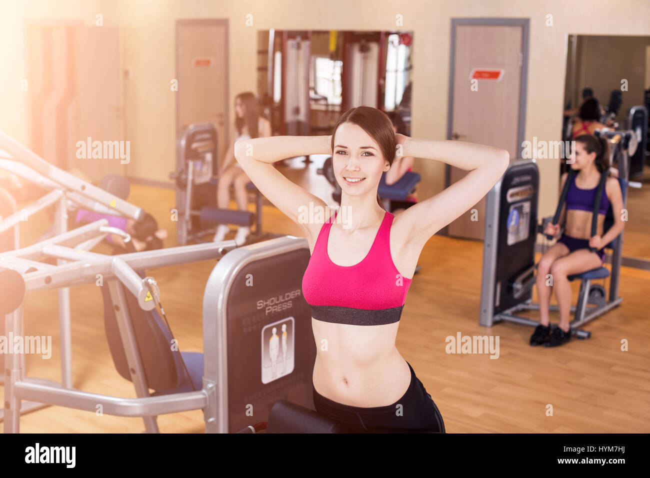 Young woman doing exercises in gym Stock Photo