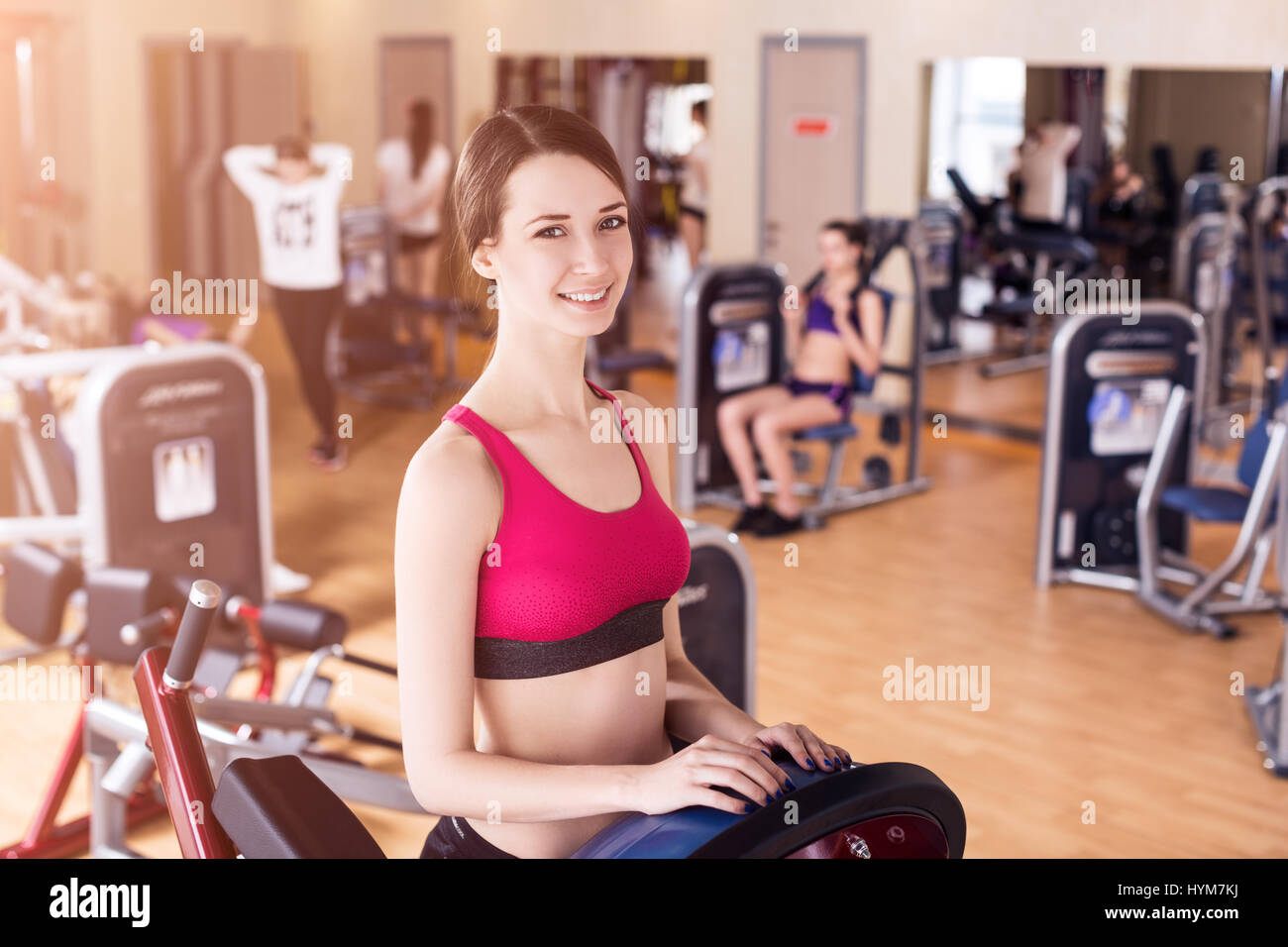 Young woman doing exercises in gym Stock Photo