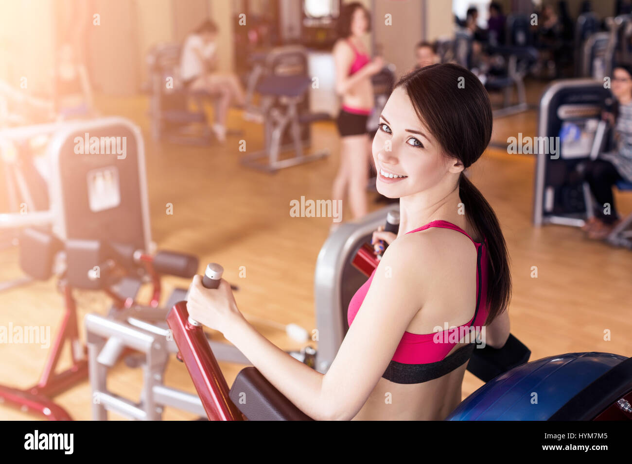 Young woman doing exercises in gym Stock Photo