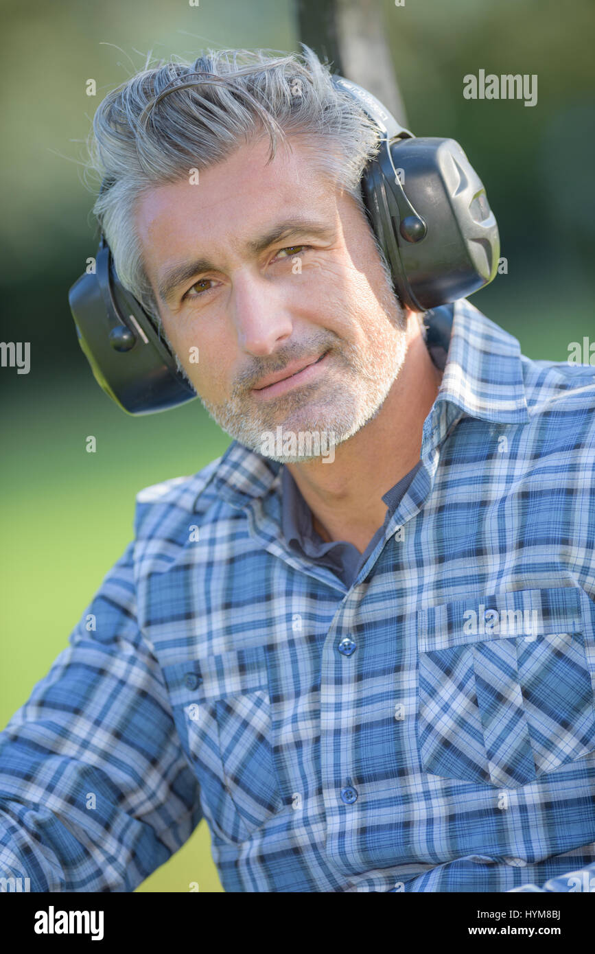 Portrait of middle aged man wearing earmuffs Stock Photo Alamy