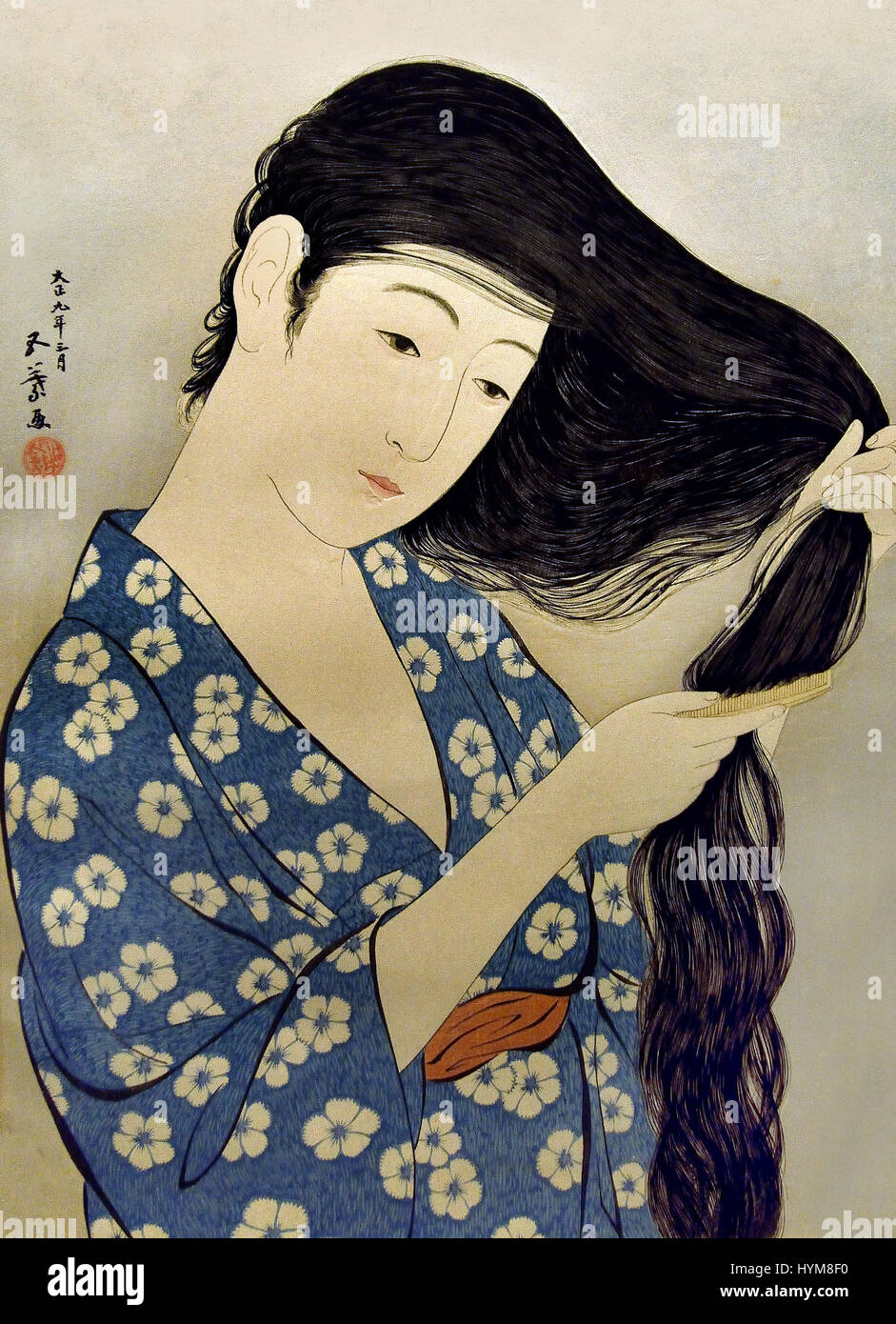 Woman in blue bathrobe combing her long hair 1920 by Hashiguchi Goyo  1880-1921 Japan Japanese Stock Photo