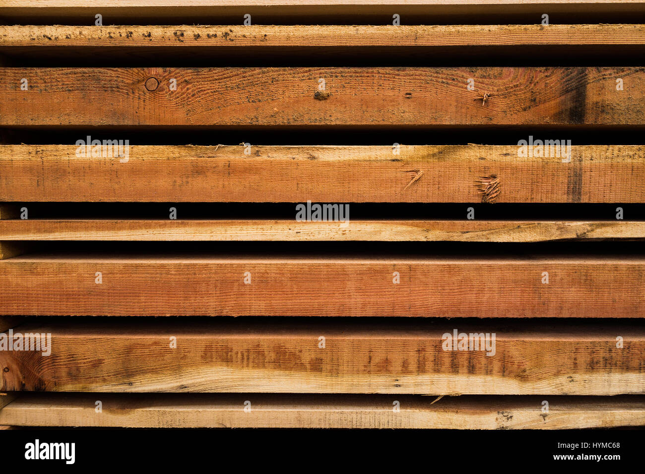 Wooden planks cut at sawmill and stacked in pile ready for use as building material Stock Photo
