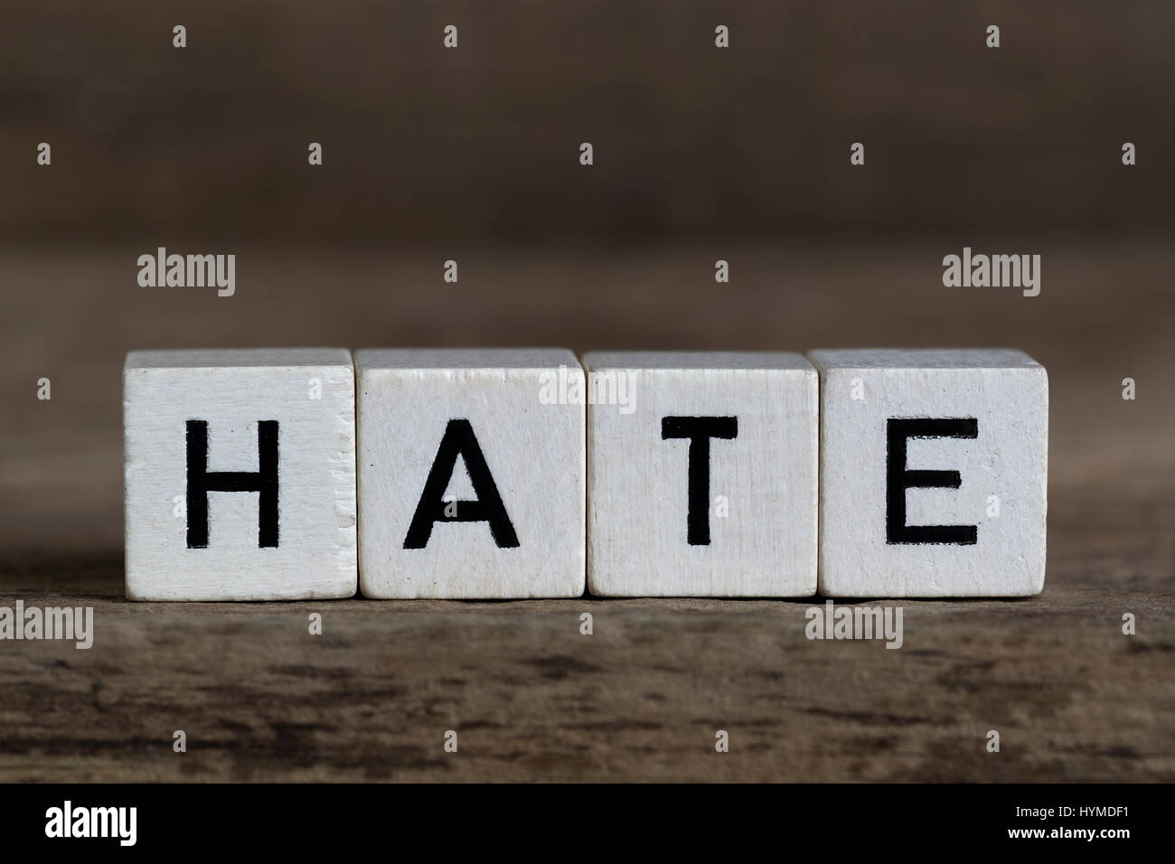 Hate, written in cubes on a wooden background Stock Photo