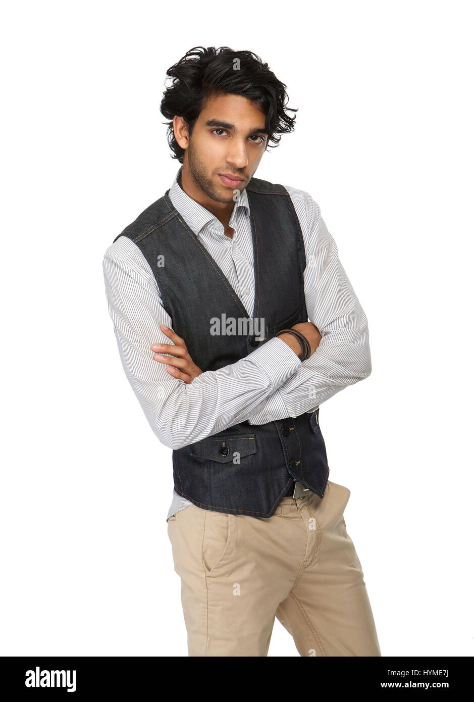 Close up portrait of a casual business man standing on isolated whet background with arms crossed Stock Photo