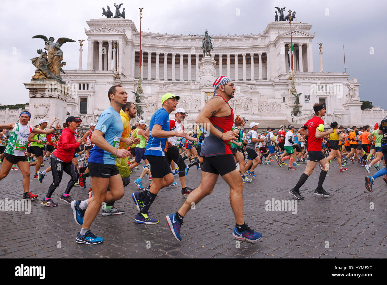 Rome, Italy - April 2, 2017: Athletes participating at the 23rd Rome marathon run through the street circuit passing in front of the altar of the home Stock Photo