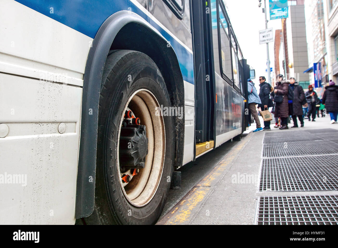 People are boarding an MTA city bus in Manhattan. Stock Photo