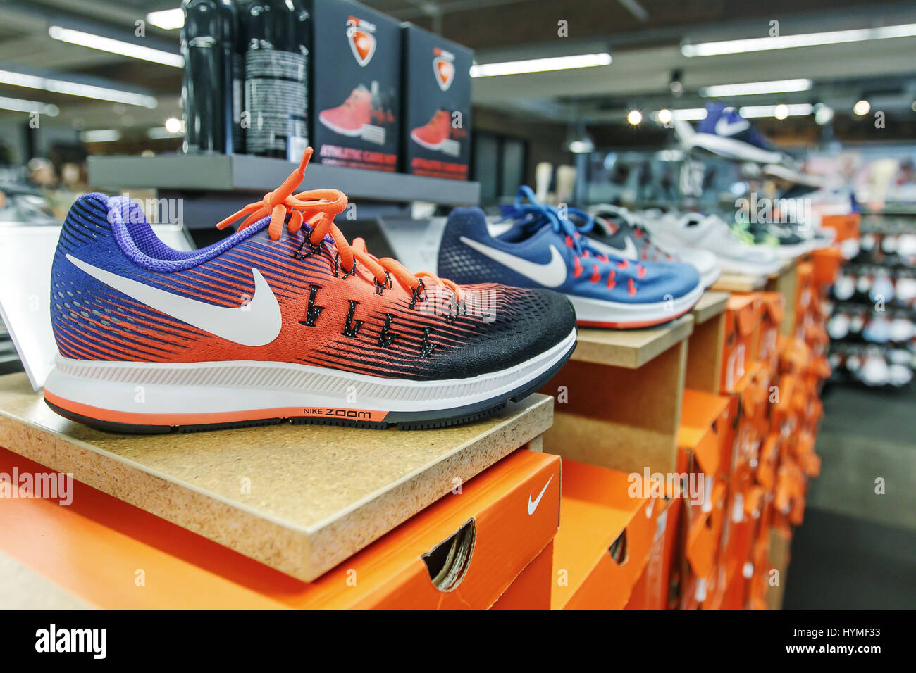 Nike shoes are set on display in a shoe store. Stock Photo