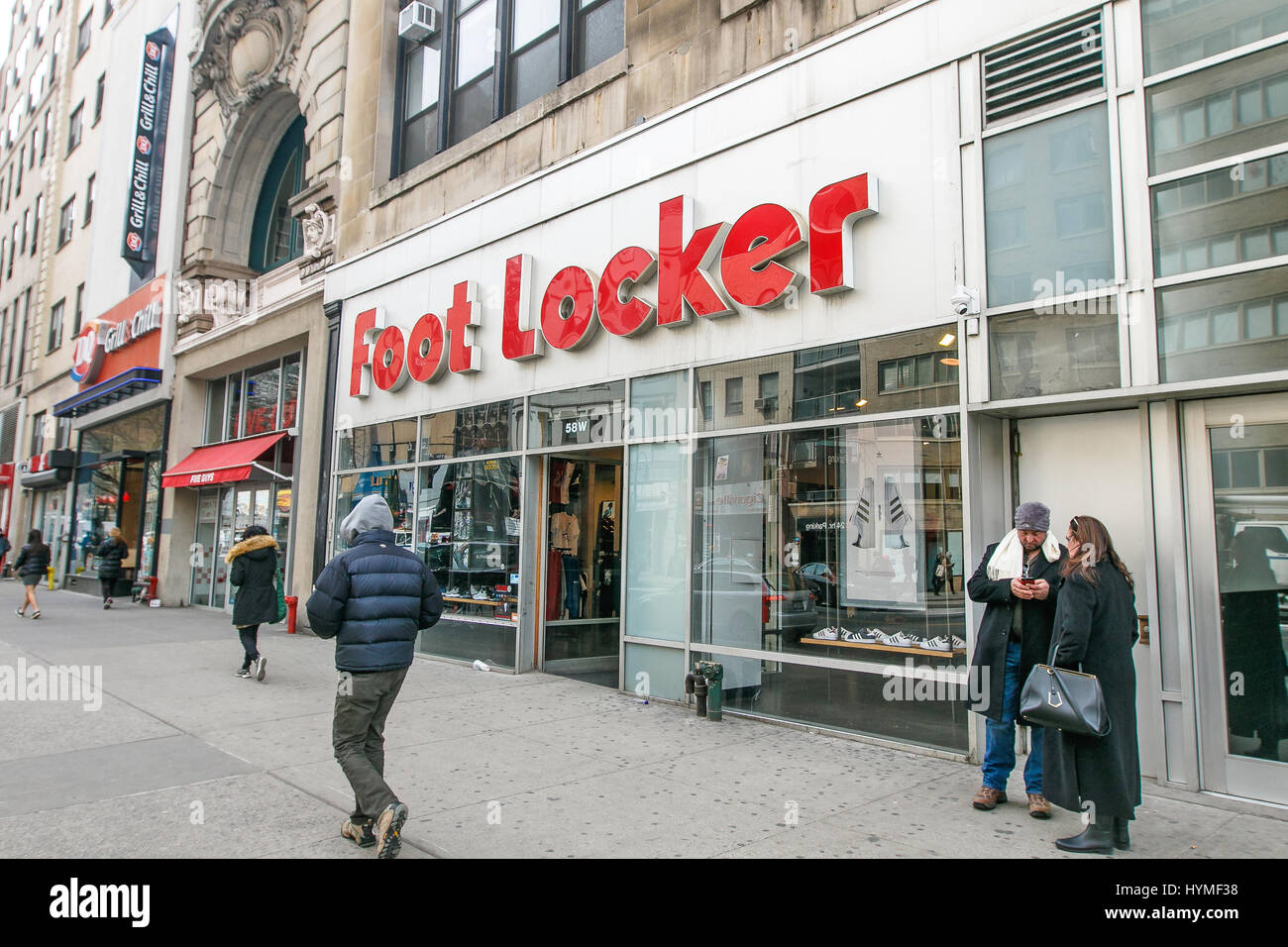 People walk by an Foot Locker store in Manhattan. Stock Photo