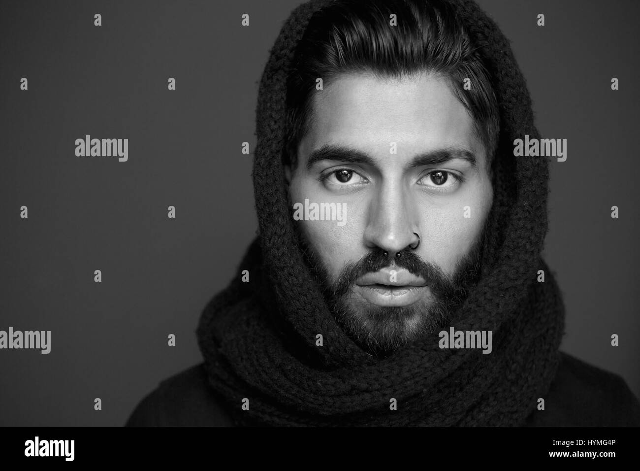 Close up black and white portrait of a man with wool scarf Stock Photo