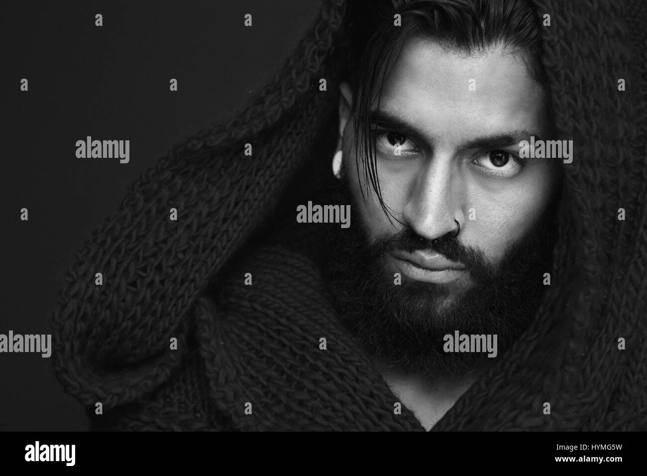 Close up black and white portrait of a fashionable man with beard and wool scarf Stock Photo