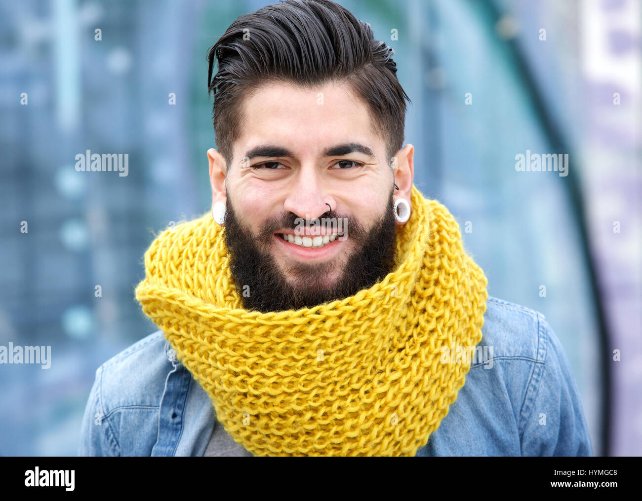 Close up portrait of a young modern man with beard smiling Stock Photo