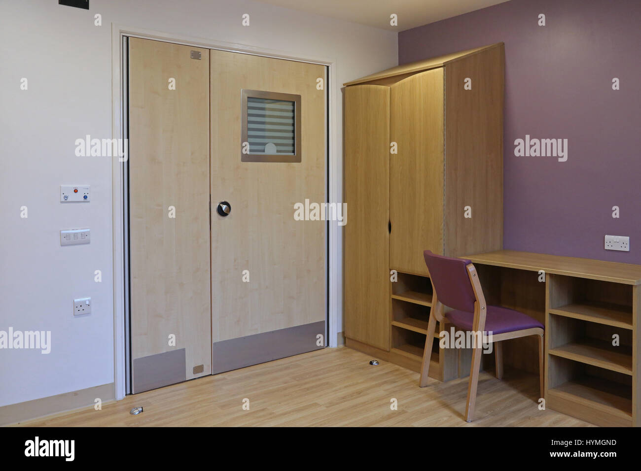 Interior of a bedroom in a new secure, residential psychiatric unit. Shows doors featuring anti-ligature door handles and lock fitting. Stock Photo