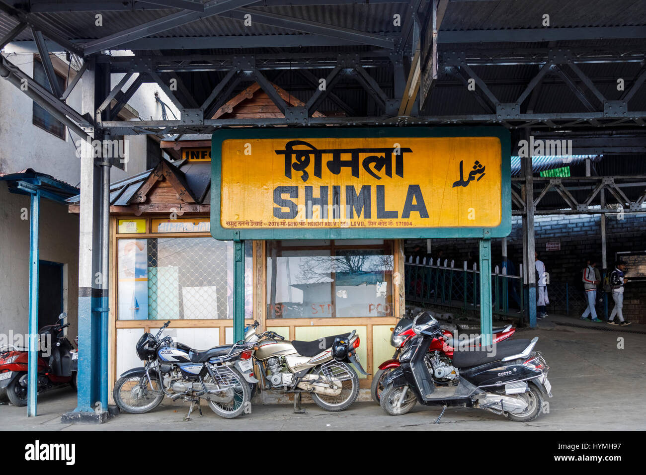 Sign, Shimla railway station, Shimla, destination end point of Toy Train Kalka–Shimla Railway, Himachal Pradesh, northern India and parked motobikes Stock Photo
