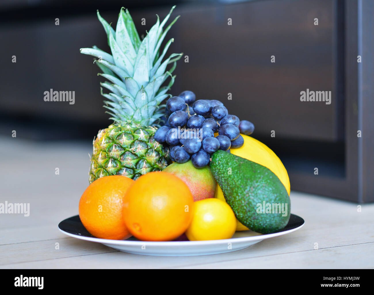 Assortment of exotic fruits on the wooden floor Stock Photo - Alamy
