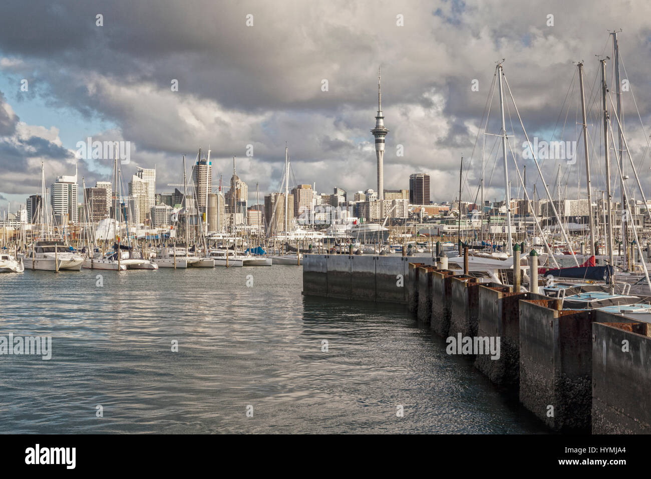 Auckland CBD and Westhaven Marina under a dramatic sunset sky. Stock Photo