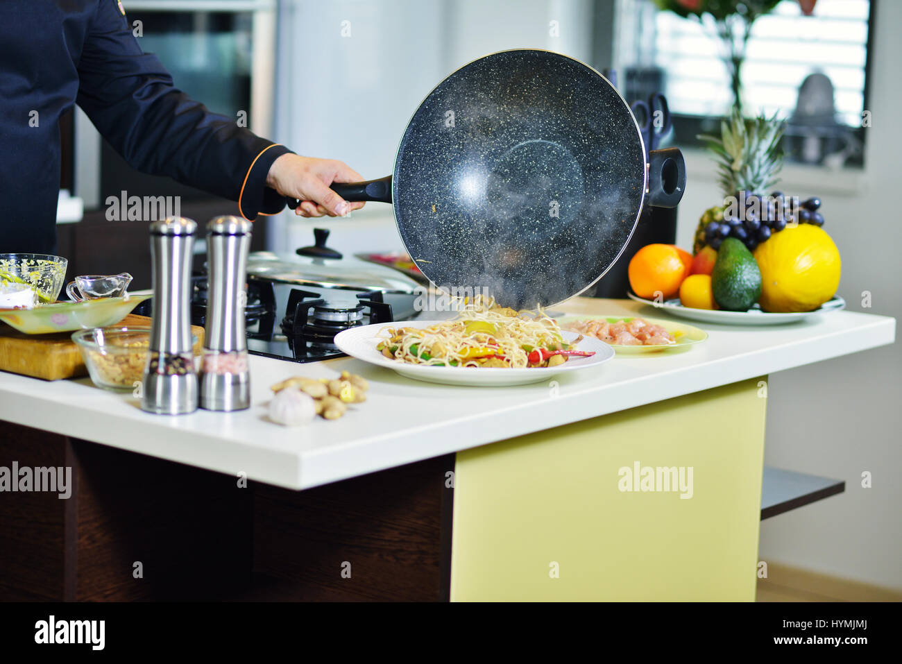 mature chef preparing a meal with various vegetables and meat Stock ...