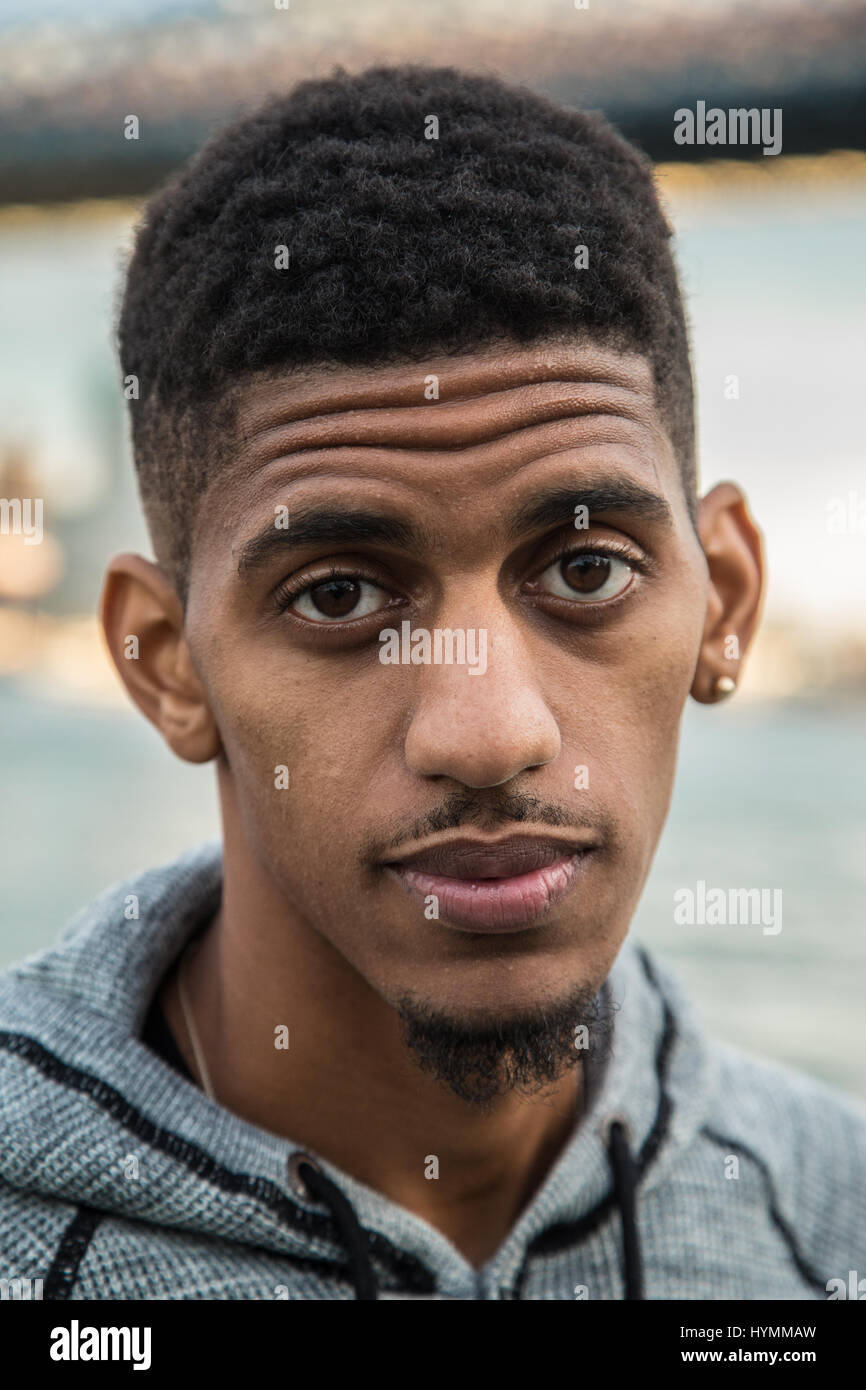 A closeup portrait of a young, black man in New York City. Shot during ...