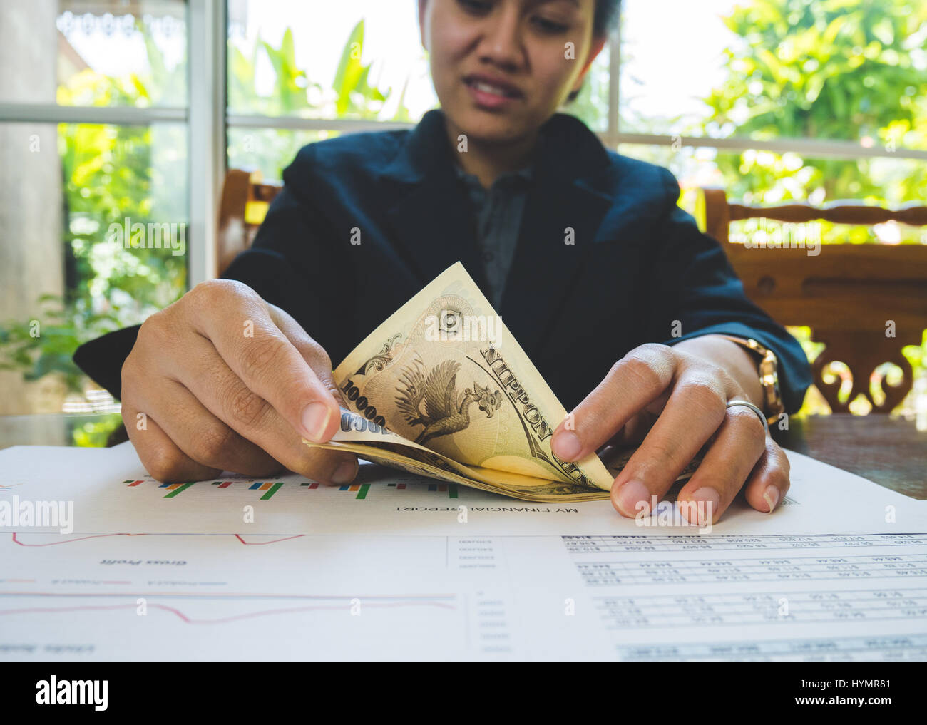 Woman is counting money with statement paper financial concept Stock Photo