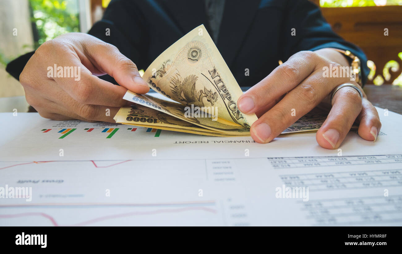 Woman is counting money with statement paper financial concept Stock Photo