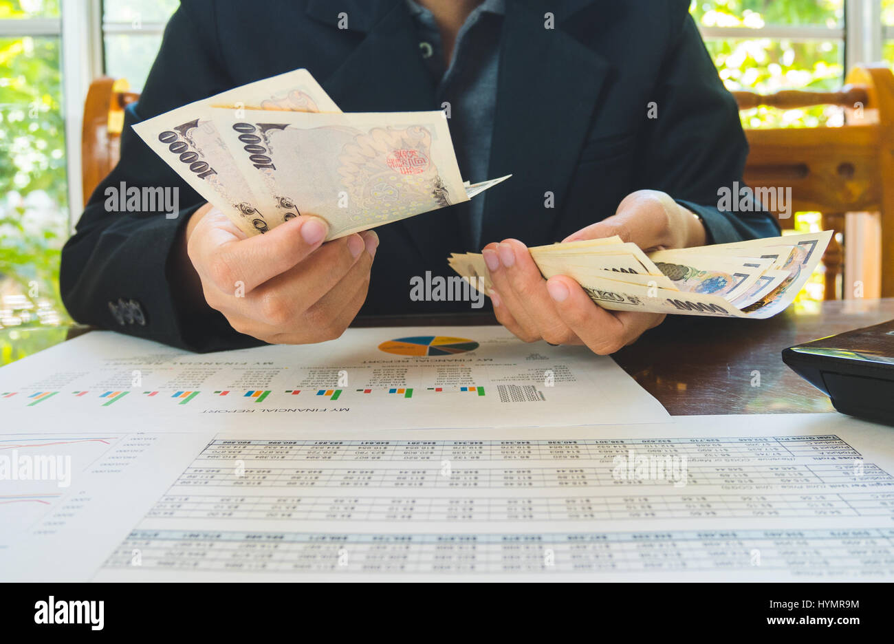 Woman is counting money with statement paper financial concept Stock Photo