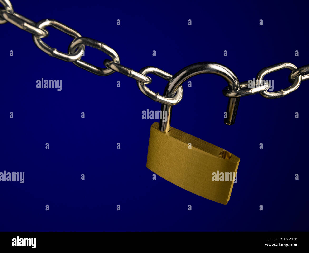 Padlock and chain on blue Stock Photo