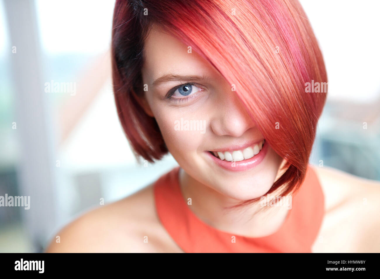 Candid portrait of a young woman smiling with red hair Stock Photo