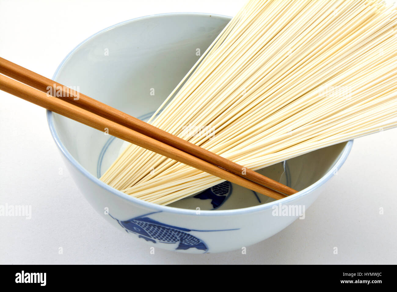 Closeup of dried Japanese noodles in a bowl with chopsticks Stock Photo