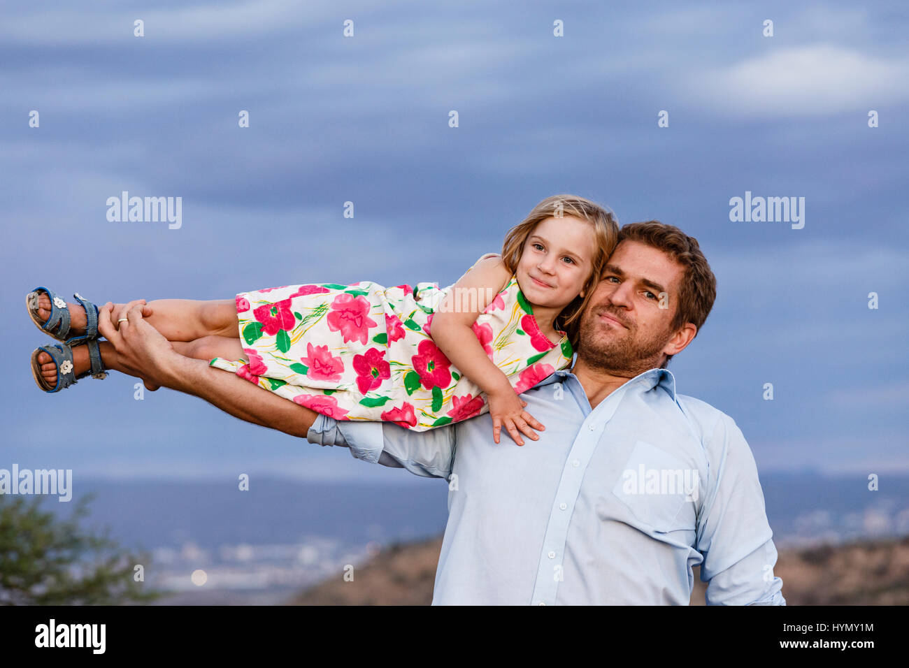 Father holding his baby daughter in his arm, Windhoek, Khomas, Namibia Stock Photo