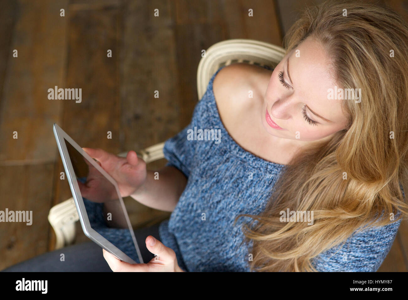 Portrait of a woman learning how to use touchscreen tablet Stock Photo