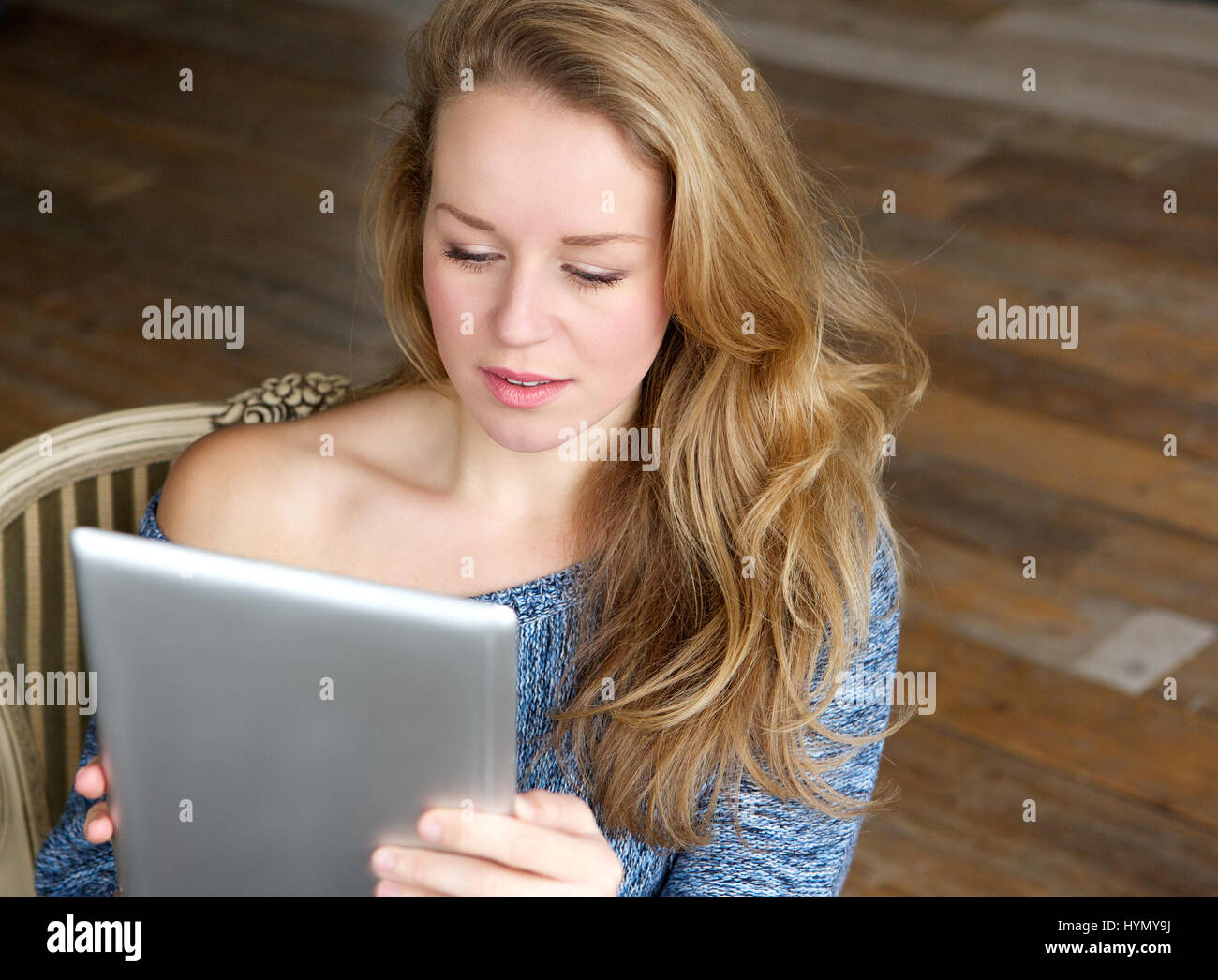 Portrait of a young woman learning how to use touchscreen tablet Stock Photo