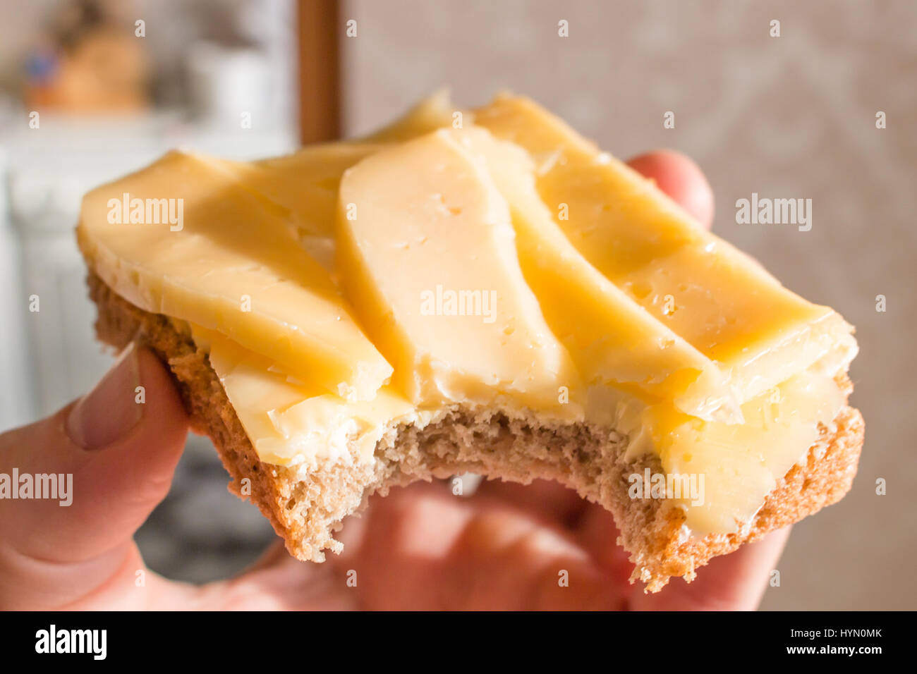 Bitten Sandwich Made Of Rye Bread Butter And Cheese In A Man S Hand Stock Photo Alamy
