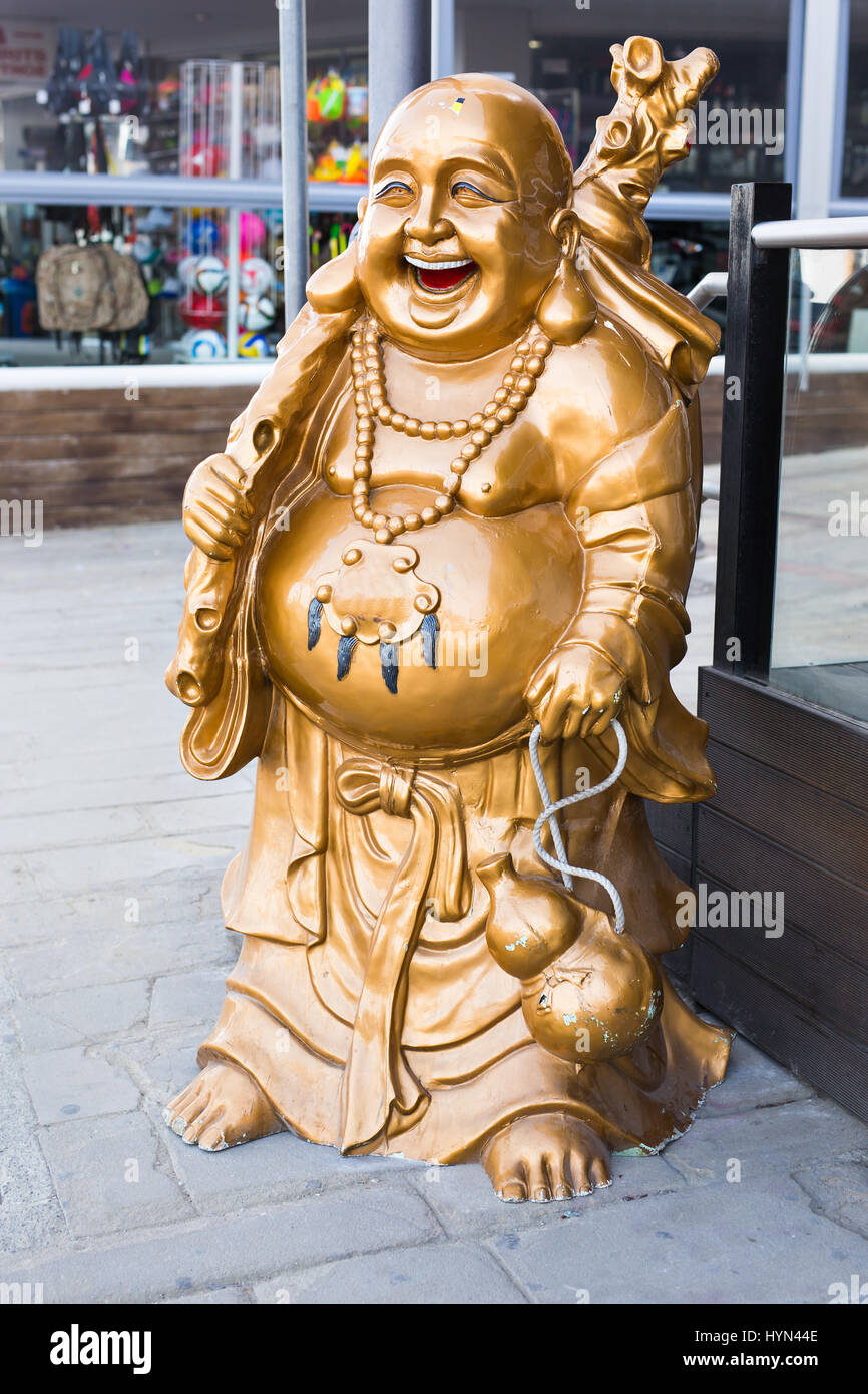 Smiling Buddha - Chinese God of Happiness, Wealth and Lucky on background Stock Photo
