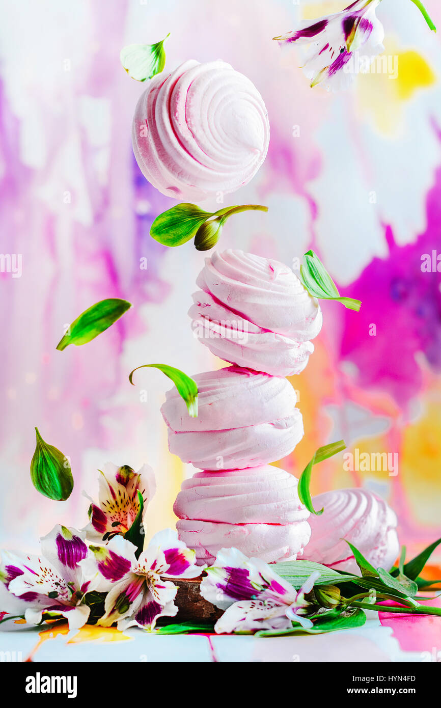 Pink marshmallow zephyr with spring flowers on a watercolor background Stock Photo