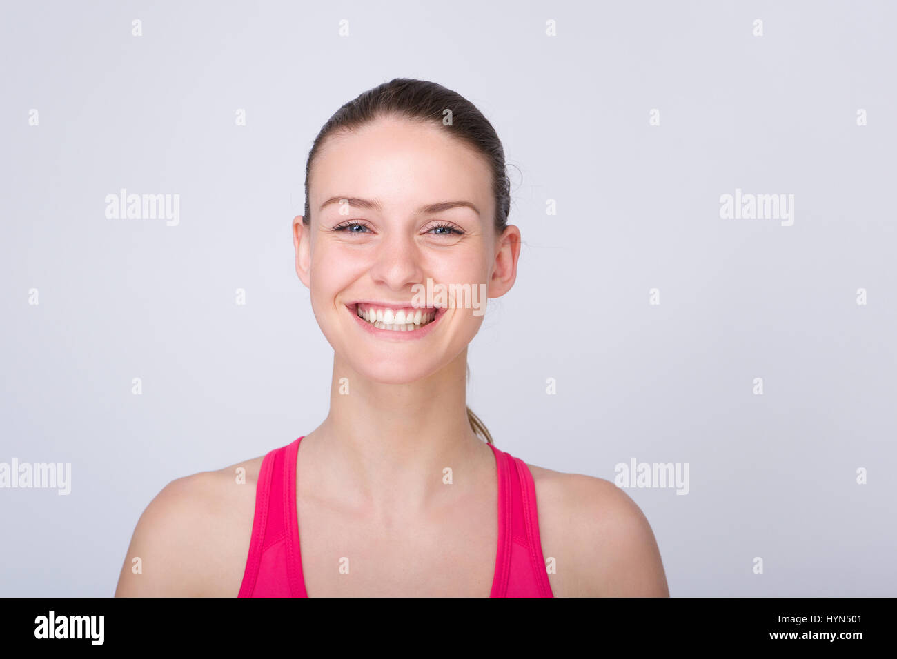 Close up portrait of a beautiful young athletic woman smiling on ...