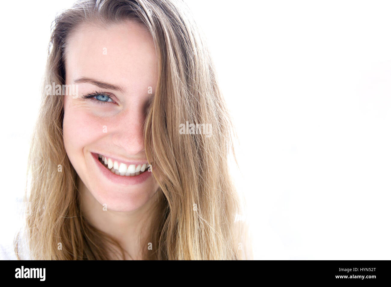 Close up portrait of a cute young woman smiling on white background ...