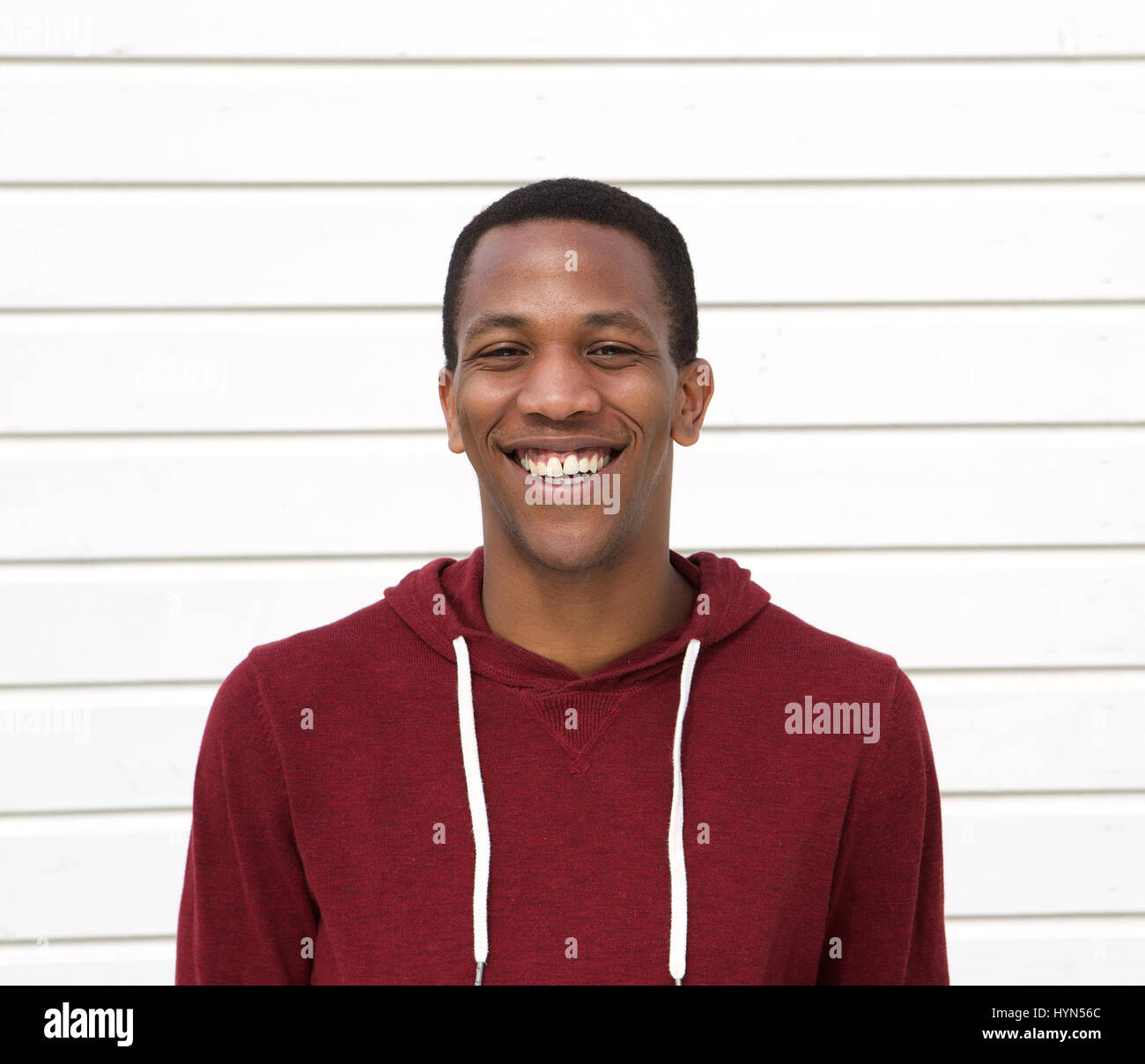 Close up portrait of a handsome young black man smiling on white ...