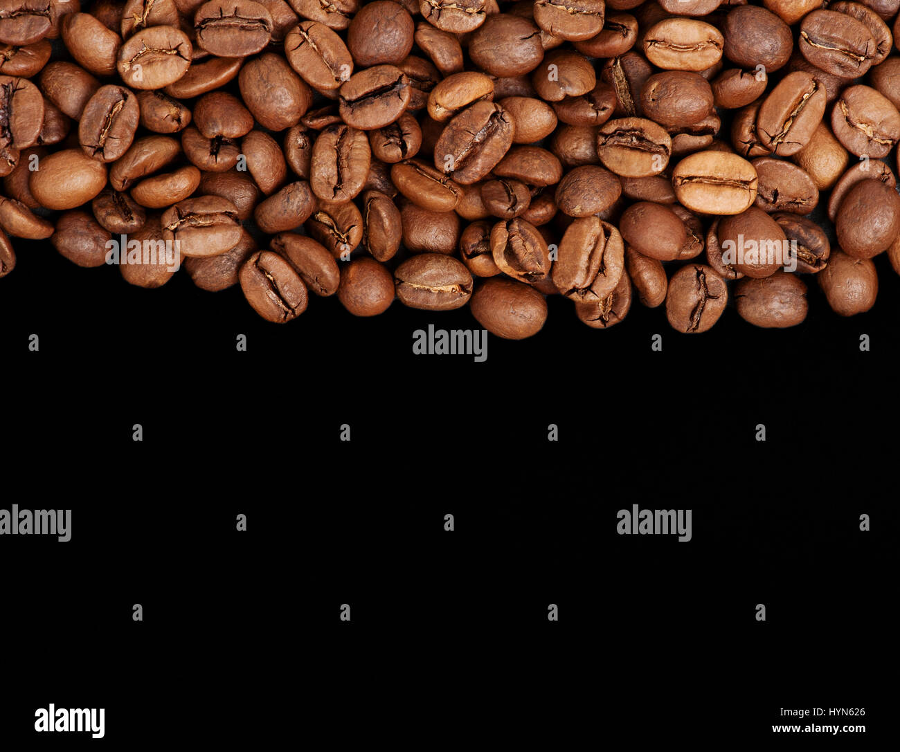 Coffee beans on the black background Stock Photo - Alamy