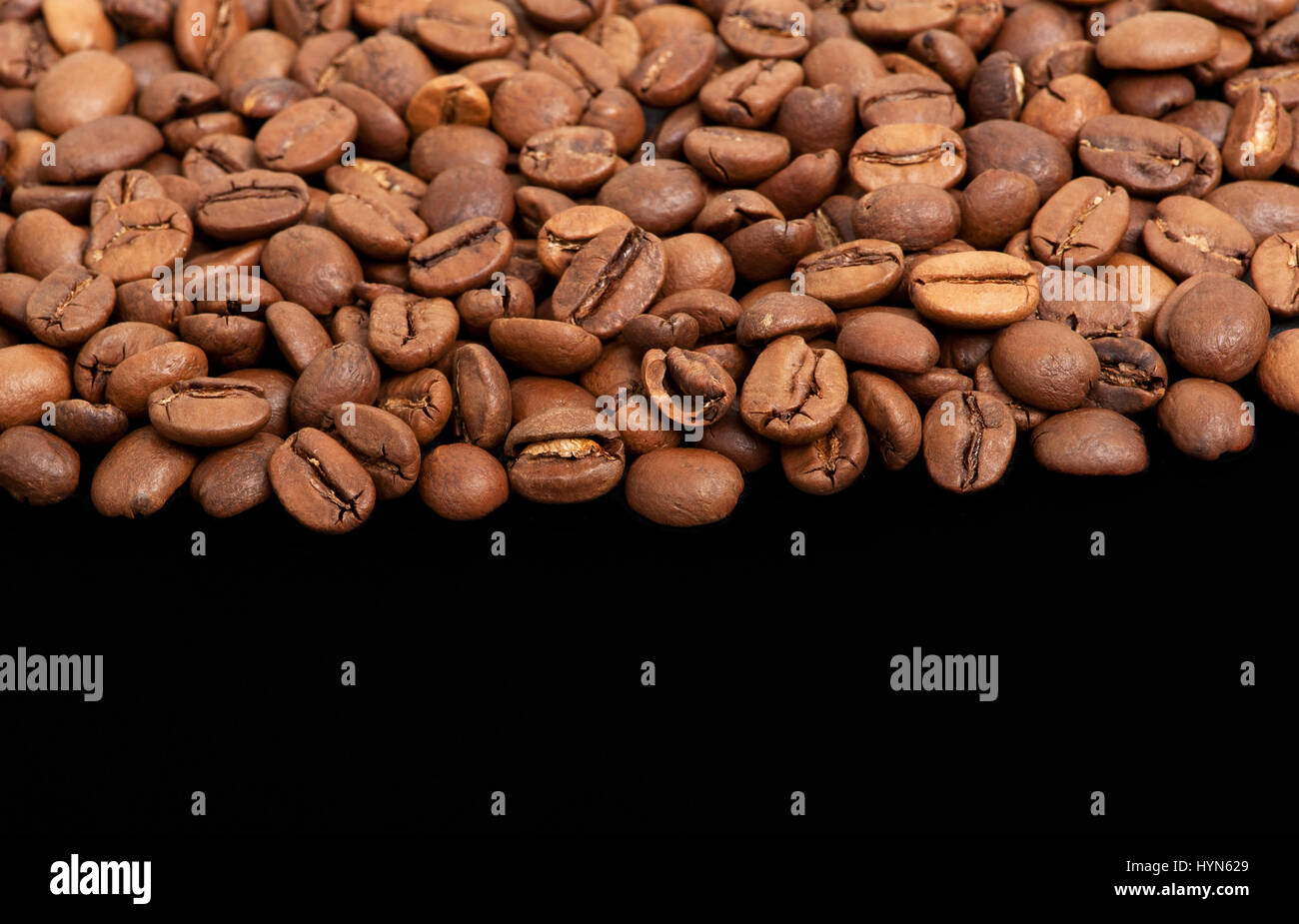 Coffee beans on the black background Stock Photo - Alamy