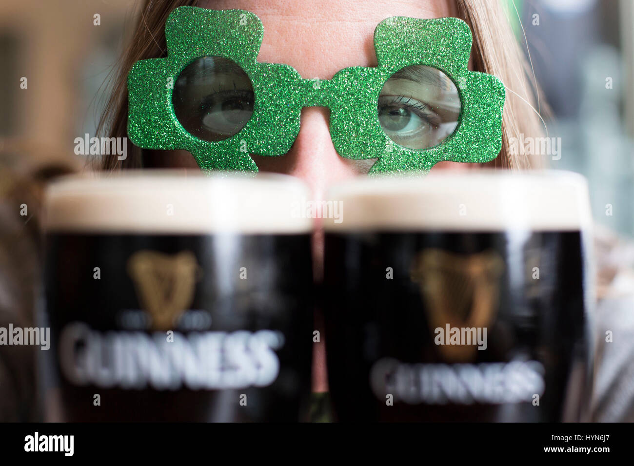 CARDIFF, WALES. 16 March 17. Anna Hammer (28), a student from Cardiff, enjoys a pint of Guinness ahead of St. Patrick’s day 2017 in O’Neill’s Irish Pu Stock Photo