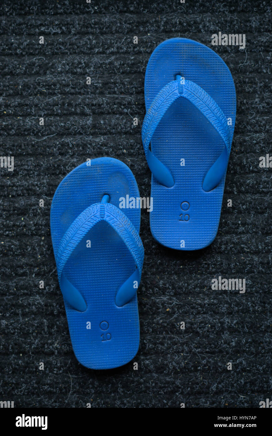 Rubber flip flops in blue colour. Kids flip flop or thongs in blue color. Stock Photo
