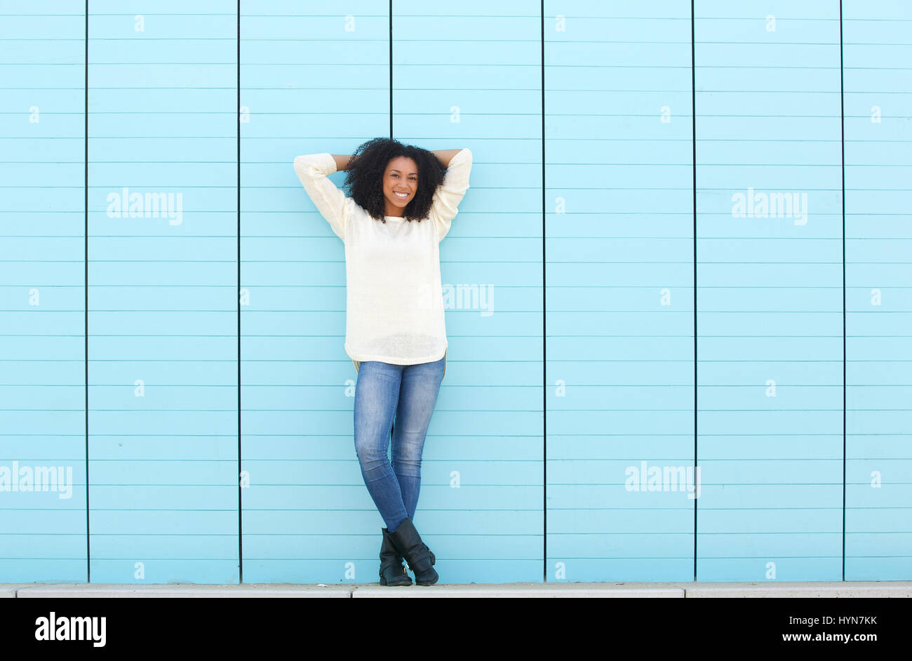 Full length portrait of a beautiful young woman smiling outdoors Stock ...