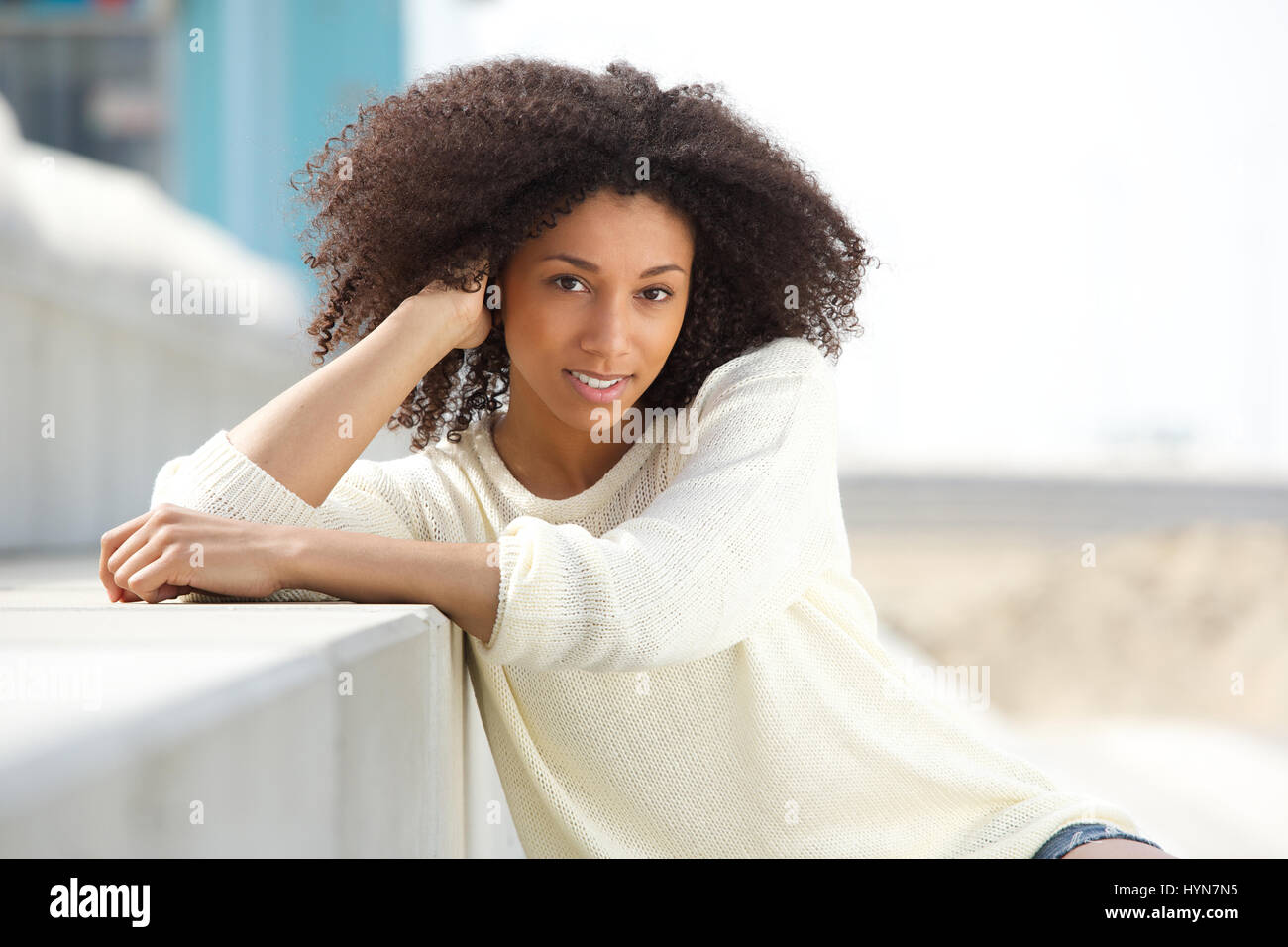 Close up portrait of a beautiful young african woman smiling outdoors ...