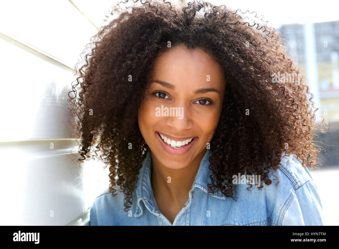 Close up portrait of a cheerful young african american woman smiling ...