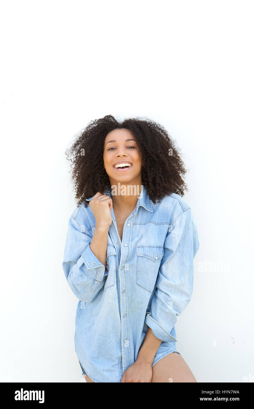Portrait of a happy young african american woman laughing on white ...