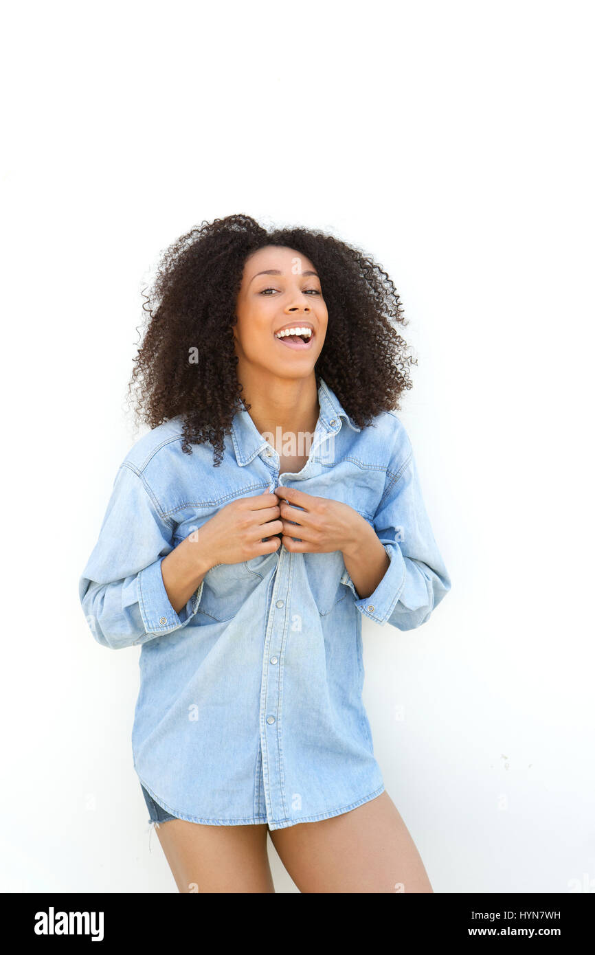 Portrait of a beautiful young african american woman laughing outdoors ...