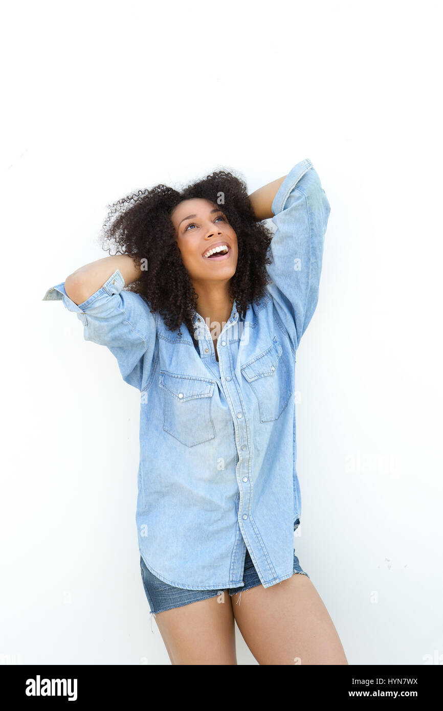 Portrait of a young african american woman smiling with hands in hair ...