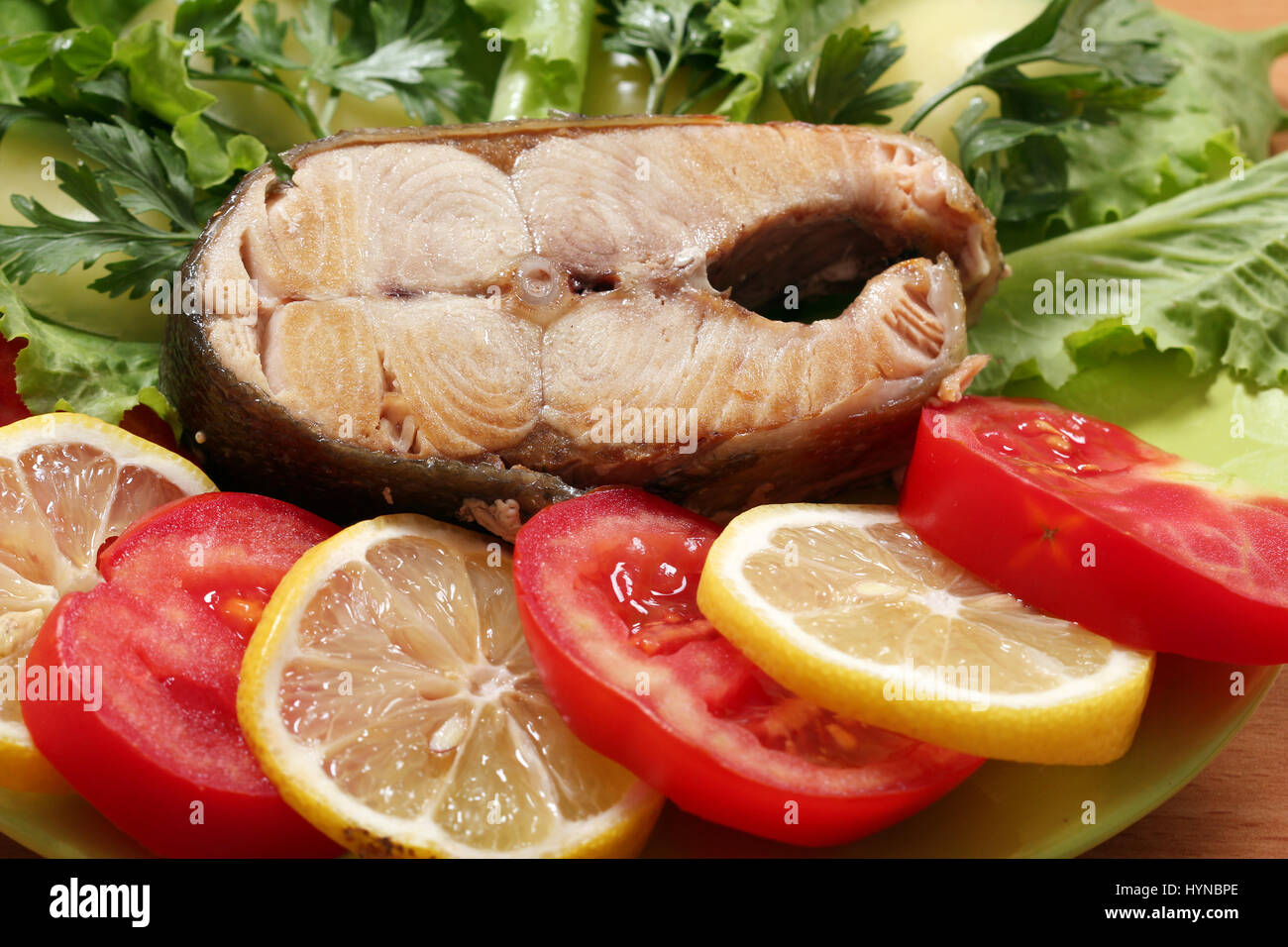 salmon with green salad tomatoes and lemon Stock Photo