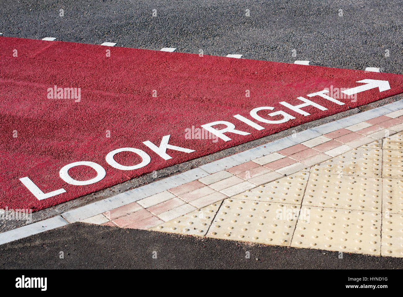 Painted Look Right road sign and arrow on a textured pedestrian crossing in Buckingham Stock Photo