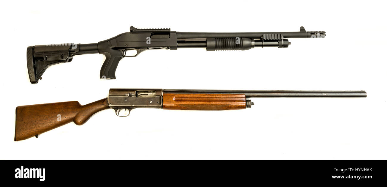 A vintage and modern tactical 12 gauge shotgun on an isolated background Stock Photo