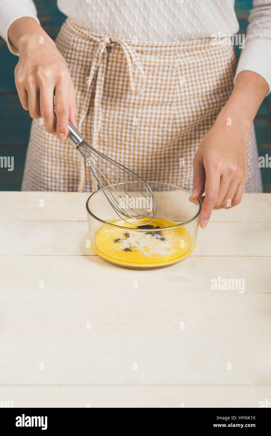 House wife wearing apron making. Steps of making cooking chocolate cake. Stock Photo
